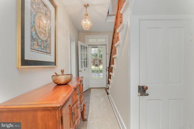 doorway featuring stairway and baseboards
