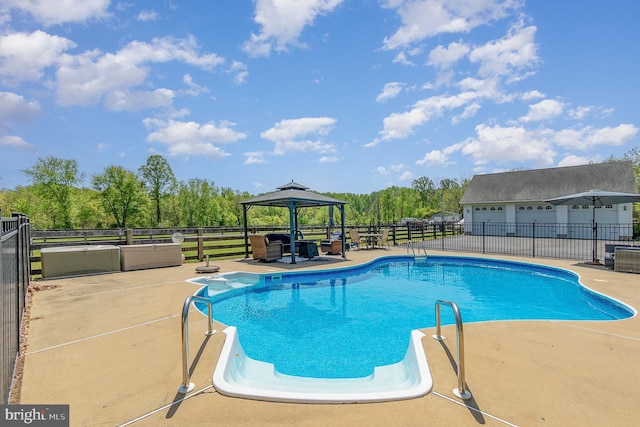 view of swimming pool featuring a gazebo, fence, a patio area, and a fenced in pool