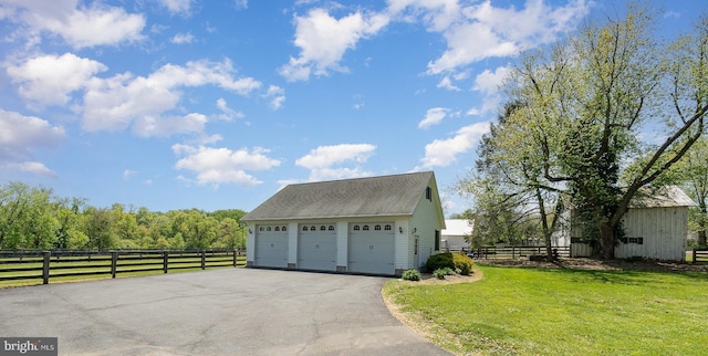 detached garage featuring fence