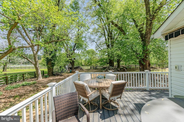 wooden terrace featuring fence and outdoor dining space