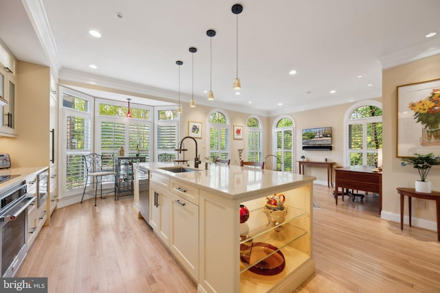 kitchen featuring recessed lighting, dishwasher, crown molding, and a sink