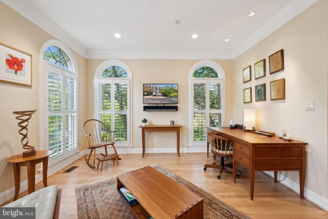 office with crown molding, light wood-style flooring, visible vents, and plenty of natural light