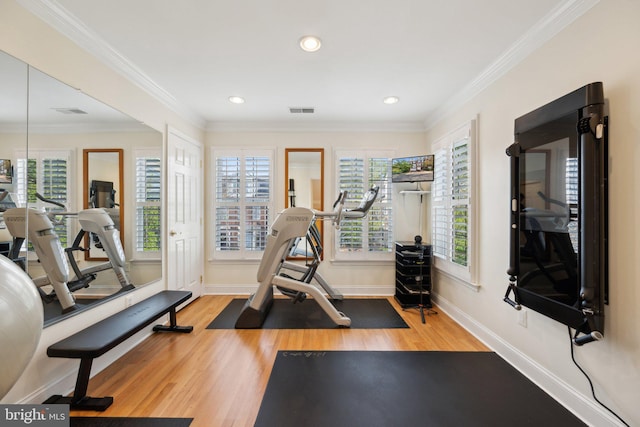 exercise room with wood finished floors, baseboards, ornamental molding, visible vents, and recessed lighting