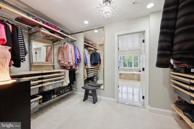 walk in closet featuring carpet flooring