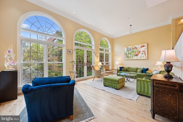 living room with light wood-style floors and crown molding