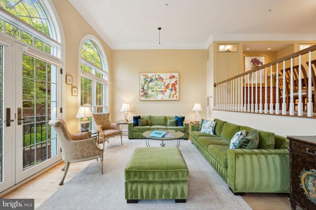 living room featuring wood finished floors and crown molding