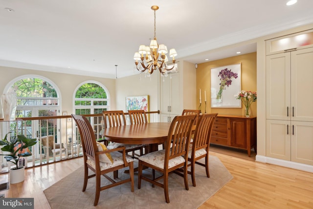 dining space with recessed lighting, crown molding, a chandelier, and light wood-type flooring