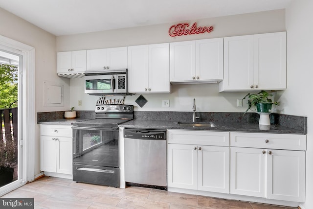 7329 Split Rail Ln, Laurel, MD 20707 - kitchen with stainless steel appliances, a sink, white cabinetry, and dark stone countertops