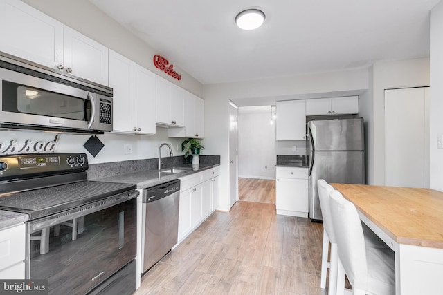 7329 Split Rail Ln, Laurel, MD 20707 - kitchen featuring stainless steel appliances, a sink, white cabinetry, light wood-style flooring, and butcher block countertops
