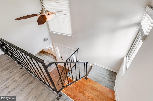 7329 Split Rail Ln, Laurel, MD 20707 - stairway featuring a ceiling fan, wood finished floors, baseboards, and a high ceiling