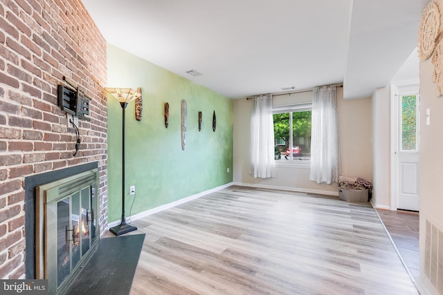 7329 Split Rail Ln, Laurel, MD 20707 - unfurnished living room with a fireplace, wood finished floors, healthy amount of natural light, and baseboards