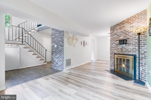 7329 Split Rail Ln, Laurel, MD 20707 - unfurnished living room featuring wood finished floors, stairs, a fireplace, and baseboards