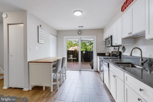 7329 Split Rail Ln, Laurel, MD 20707 - kitchen with a sink, appliances with stainless steel finishes, light wood finished floors, butcher block countertops, and white cabinets