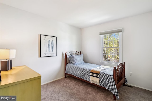 carpeted bedroom featuring baseboards