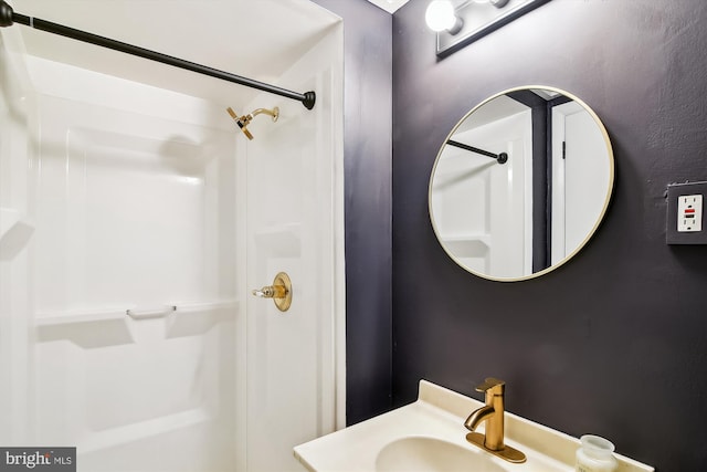 full bathroom with walk in shower and a sink