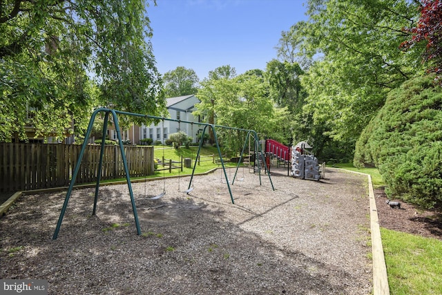 view of jungle gym featuring fence