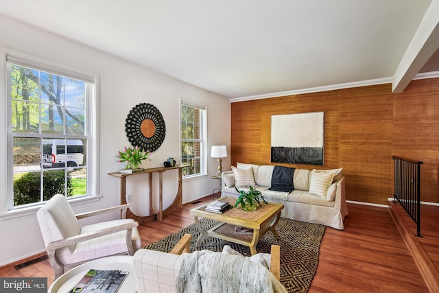 living room featuring baseboards, plenty of natural light, and visible vents