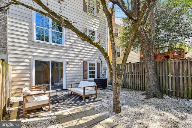 rear view of house with fence, a patio, and cooling unit