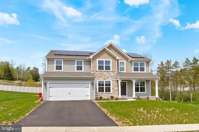 view of front of property with board and batten siding, aphalt driveway, a front yard, a porch, and a garage