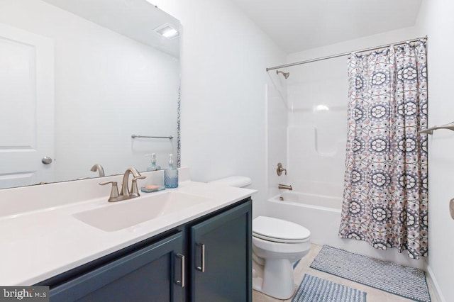 full bath with tile patterned floors, shower / tub combo, vanity, and toilet