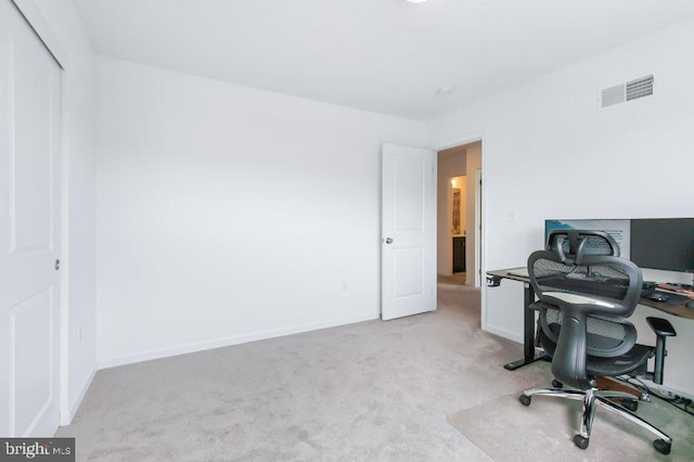 carpeted office with baseboards and visible vents