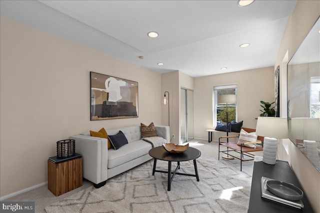 living area with baseboards, carpet floors, and recessed lighting