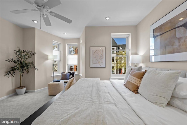 carpeted bedroom with ceiling fan, baseboards, multiple windows, and recessed lighting