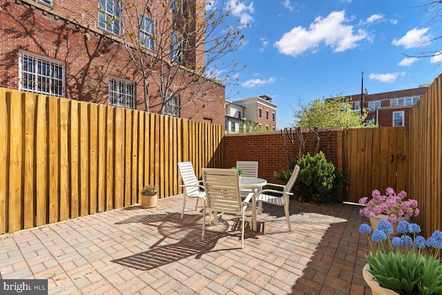 view of patio featuring a fenced backyard and outdoor dining space