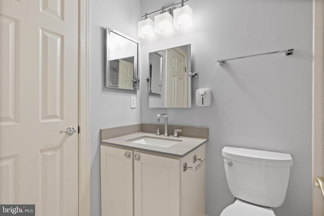 bathroom featuring toilet and vanity