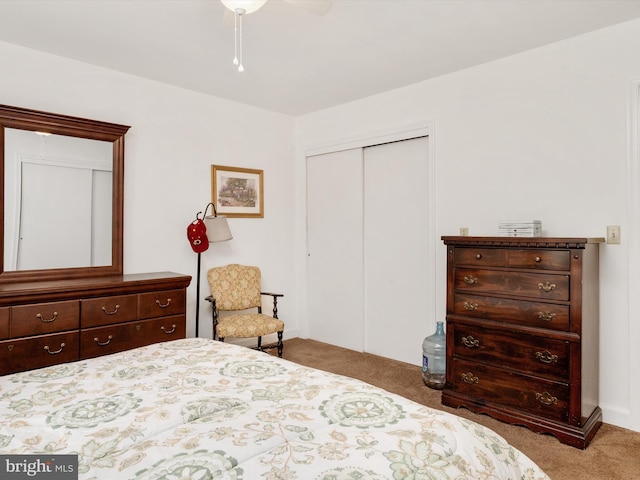 bedroom with a ceiling fan, a closet, and carpet