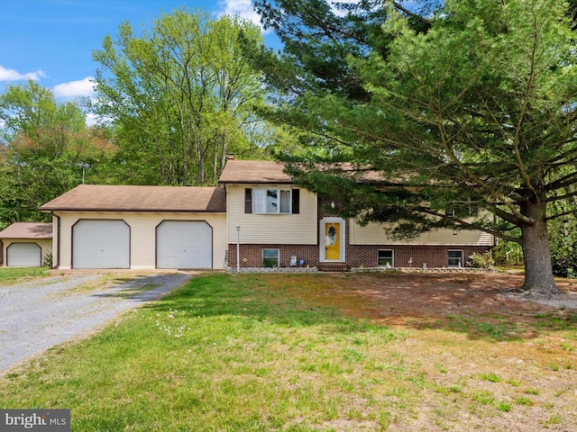 view of front of property featuring entry steps, driveway, an attached garage, and a front yard