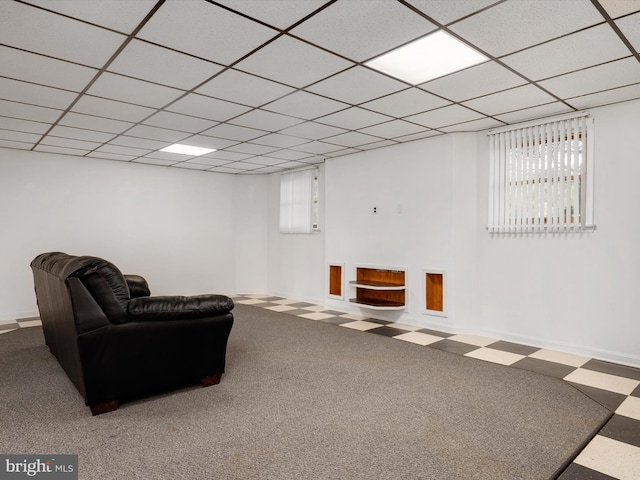 interior space featuring baseboards, carpet, and a drop ceiling