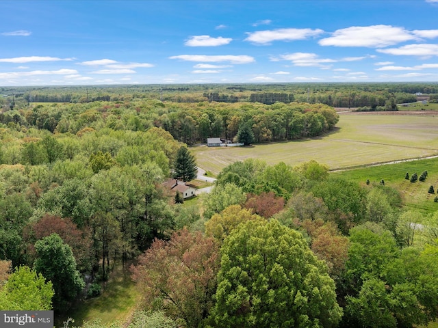 drone / aerial view featuring a rural view and a wooded view