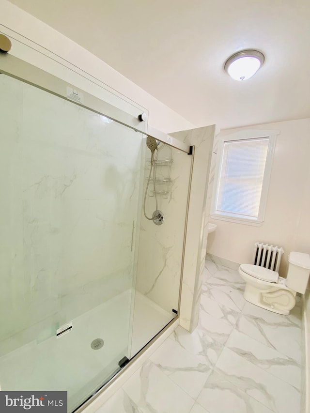 bathroom featuring radiator, toilet, marble finish floor, and a marble finish shower