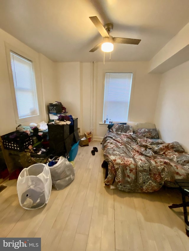 bedroom featuring wood finished floors and a ceiling fan