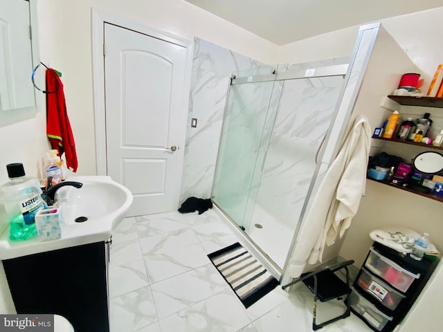 bathroom with marble finish floor, vanity, and a marble finish shower
