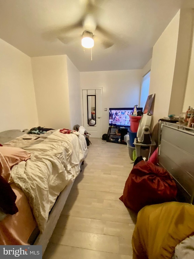 bedroom with ceiling fan and light wood-style floors