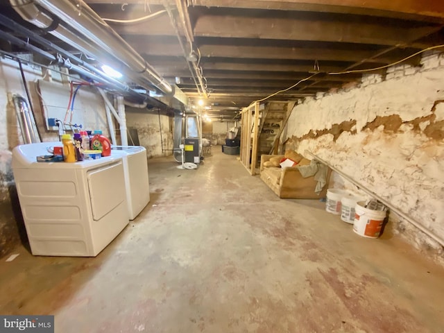unfinished below grade area with heating unit and washer and dryer