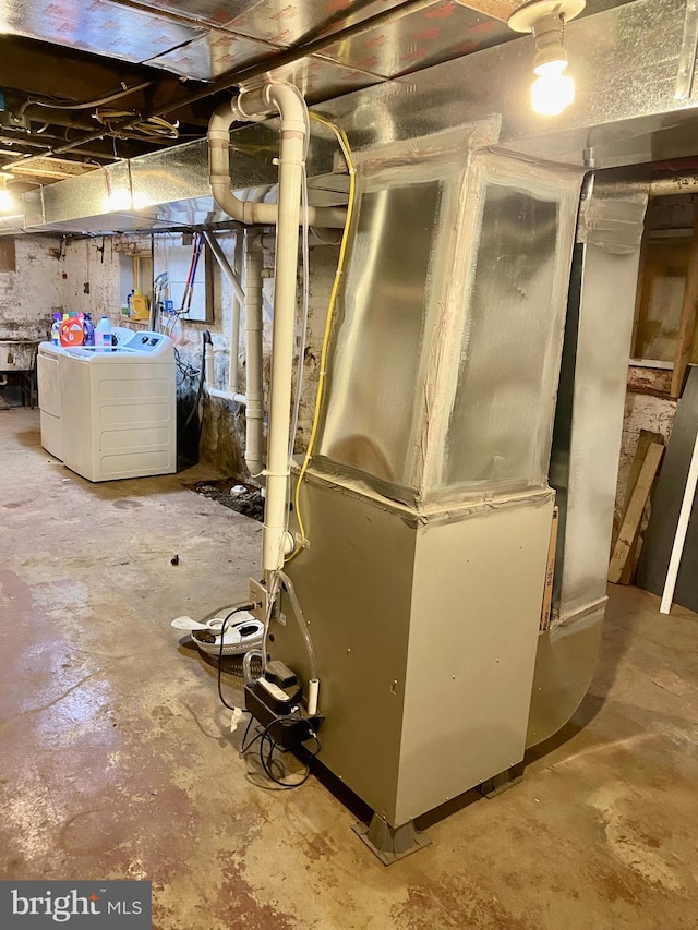 unfinished basement with washing machine and clothes dryer and heating unit