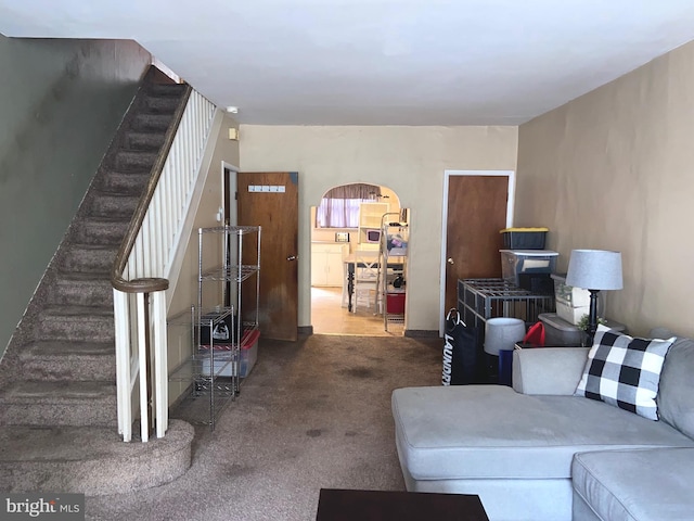 919 Dudley St, Philadelphia, PA 19148 - living room with arched walkways, carpet, and stairway