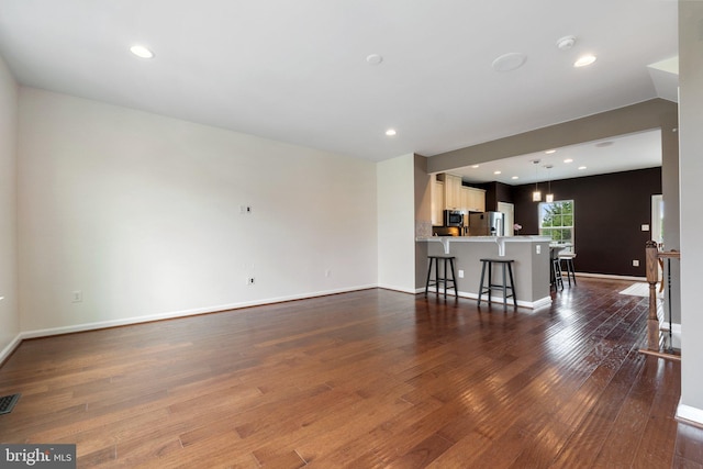 172 Trout Lily Dr, Lake Frederick, VA 22630 - unfurnished living room with dark wood finished floors, baseboards, and recessed lighting