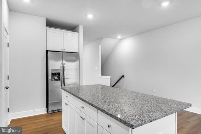 kitchen featuring wood finished floors, recessed lighting, white cabinetry, and stainless steel fridge with ice dispenser