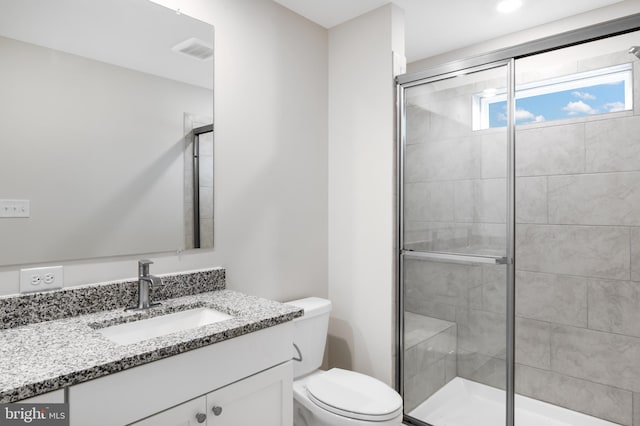 full bathroom with a shower stall, visible vents, toilet, and vanity