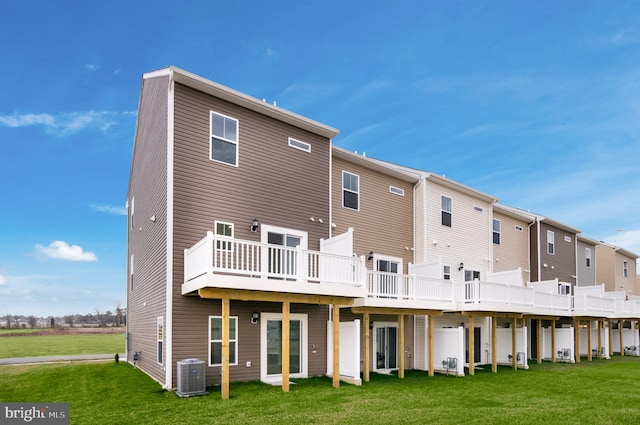 back of house with a yard, cooling unit, and a deck
