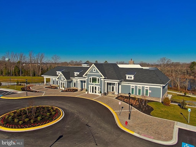 view of front of property featuring a front yard, french doors, and a chimney