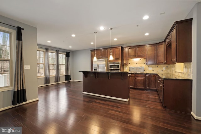 1539 Rabbit Hollow Pl, Silver Spring, MD 20906 - kitchen with stainless steel appliances, a breakfast bar area, plenty of natural light, backsplash, and recessed lighting