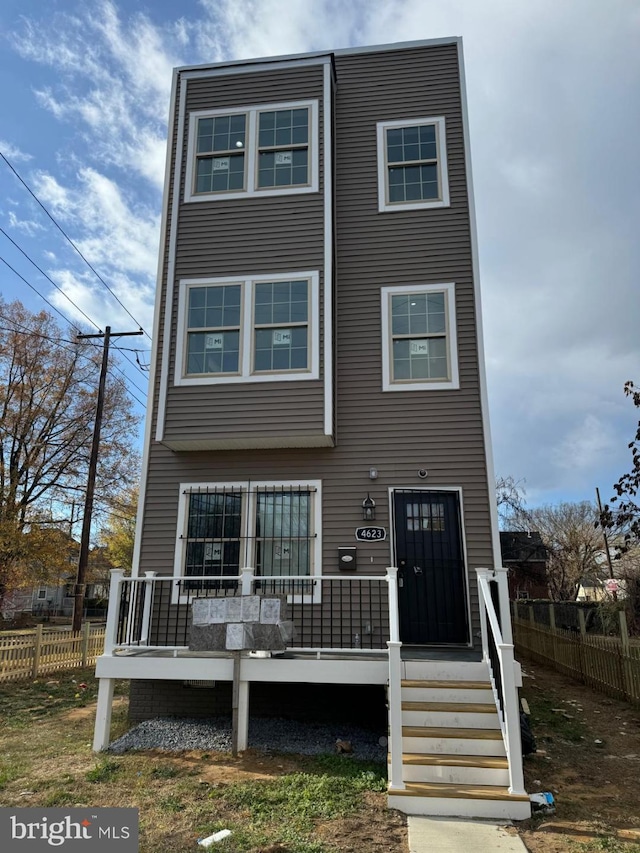 townhome / multi-family property with fence and a wooden deck