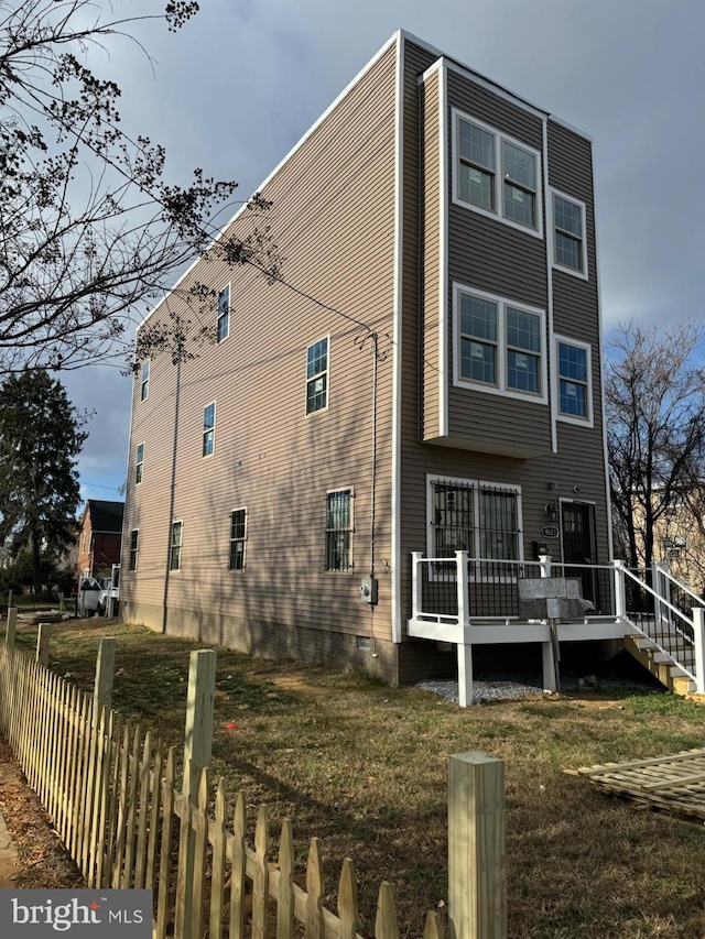 back of house featuring a wooden deck and crawl space