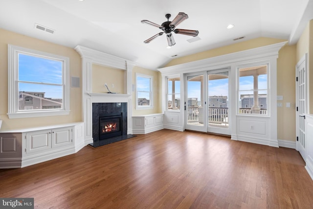 unfurnished living room with visible vents, a ceiling fan, a fireplace, and lofted ceiling
