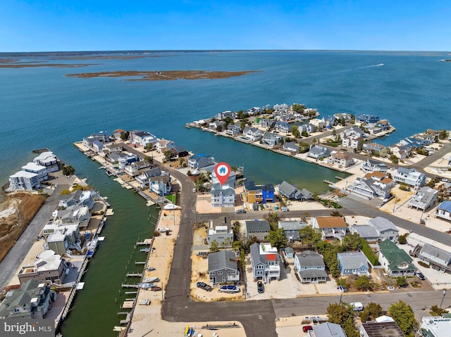 drone / aerial view featuring a water view and a residential view